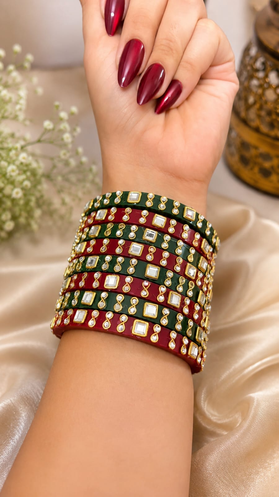 Festive bangle stack in emerald green and maroon set with kundan-style square stones, crystals and gold motifs